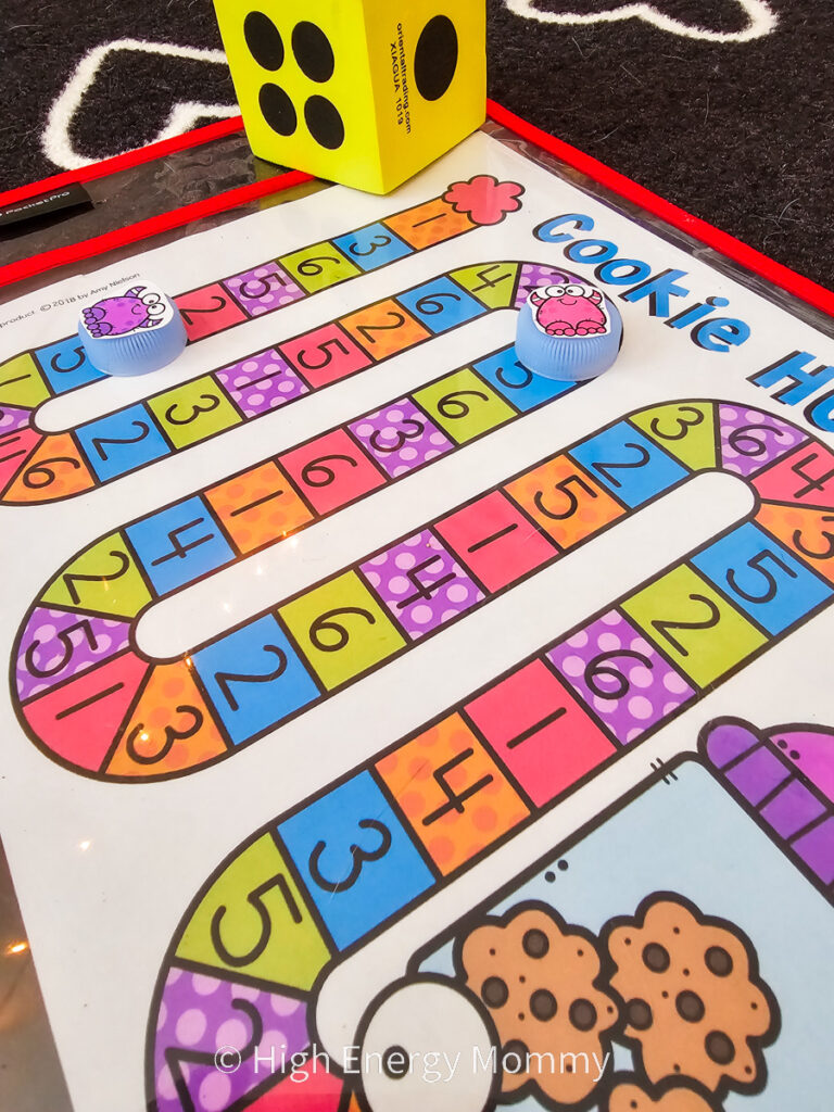 colorful board game in an up and down snake pattern with numbers 1 through 6 in squares throughout the pattern and a large yellow die