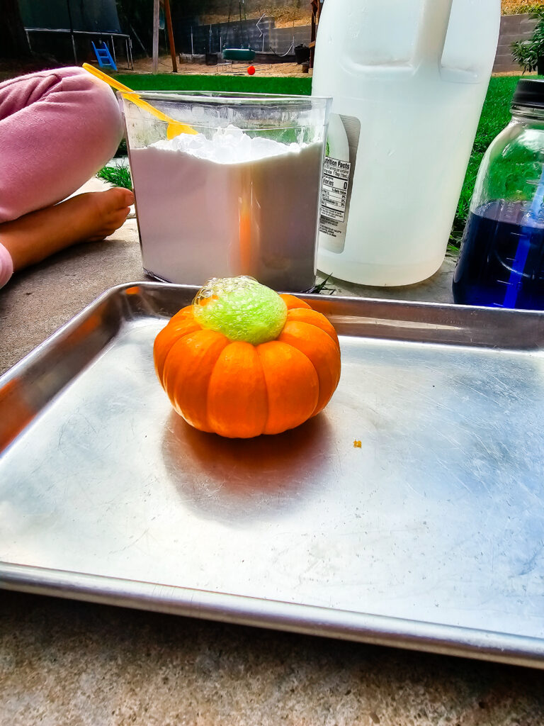 Mini Pumpkin with green bubbles and foam coming out the top