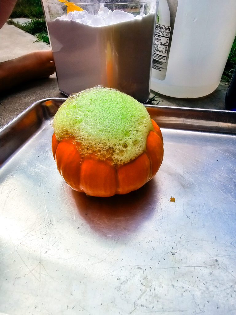Mini Pumpkin with a lot of green foam bubbling out the top