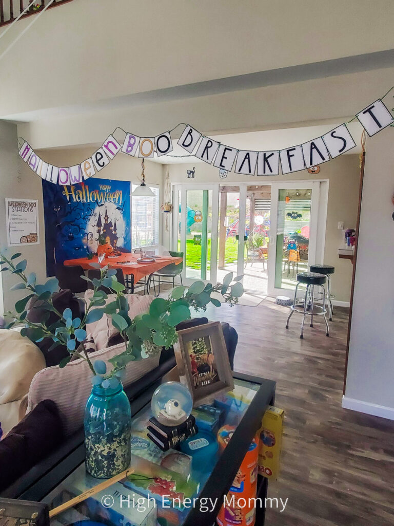 decorations in a dining room with a halloween backdrop and banner that says HALLOWEEN BOO BREAKFAST