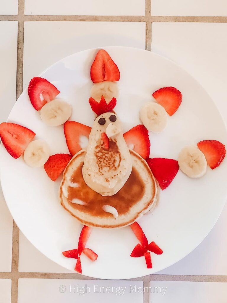 Cute turkey crafts for kids pancakes shaped like a turkey with banana and strawberry feathers