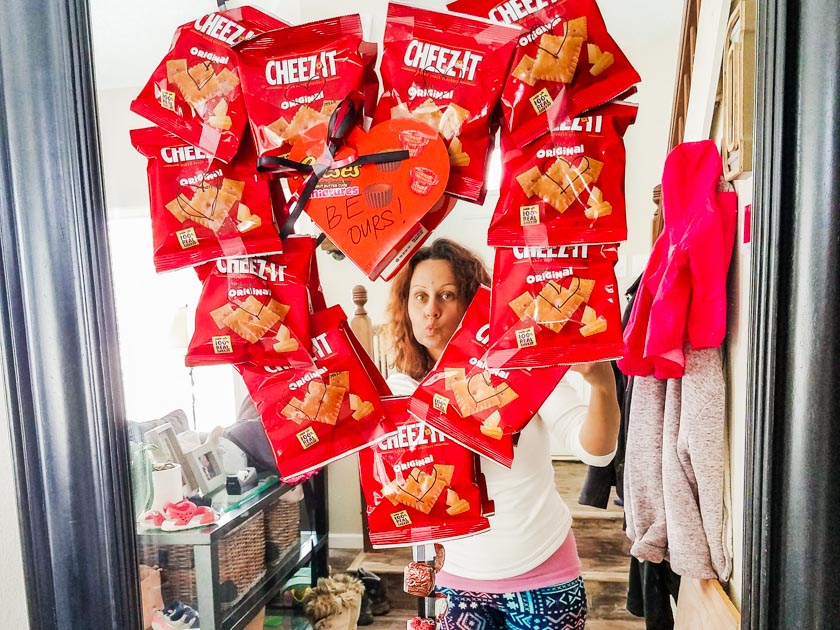 Individual bags of Cheezit crackers taped together into a heart shape like a wreath for a valentine gift