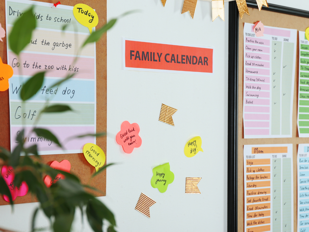 bulletin board with family calendar and lists