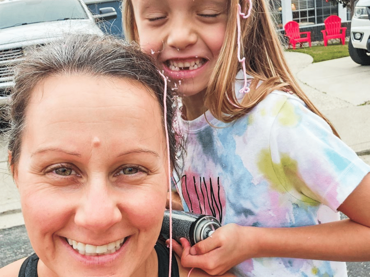 woman and girl covered in silly string laughing