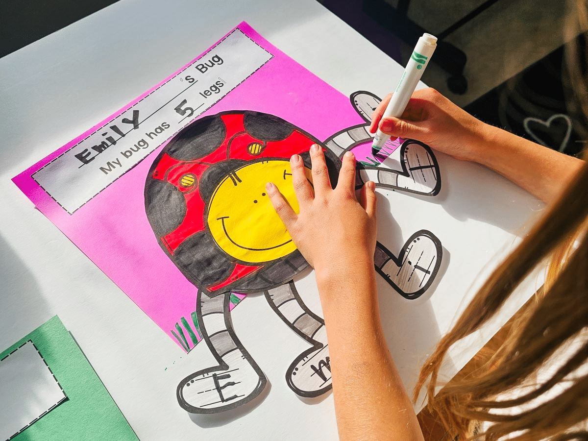 child coloring a picture of a bug with long legs that each have a letter of childs name