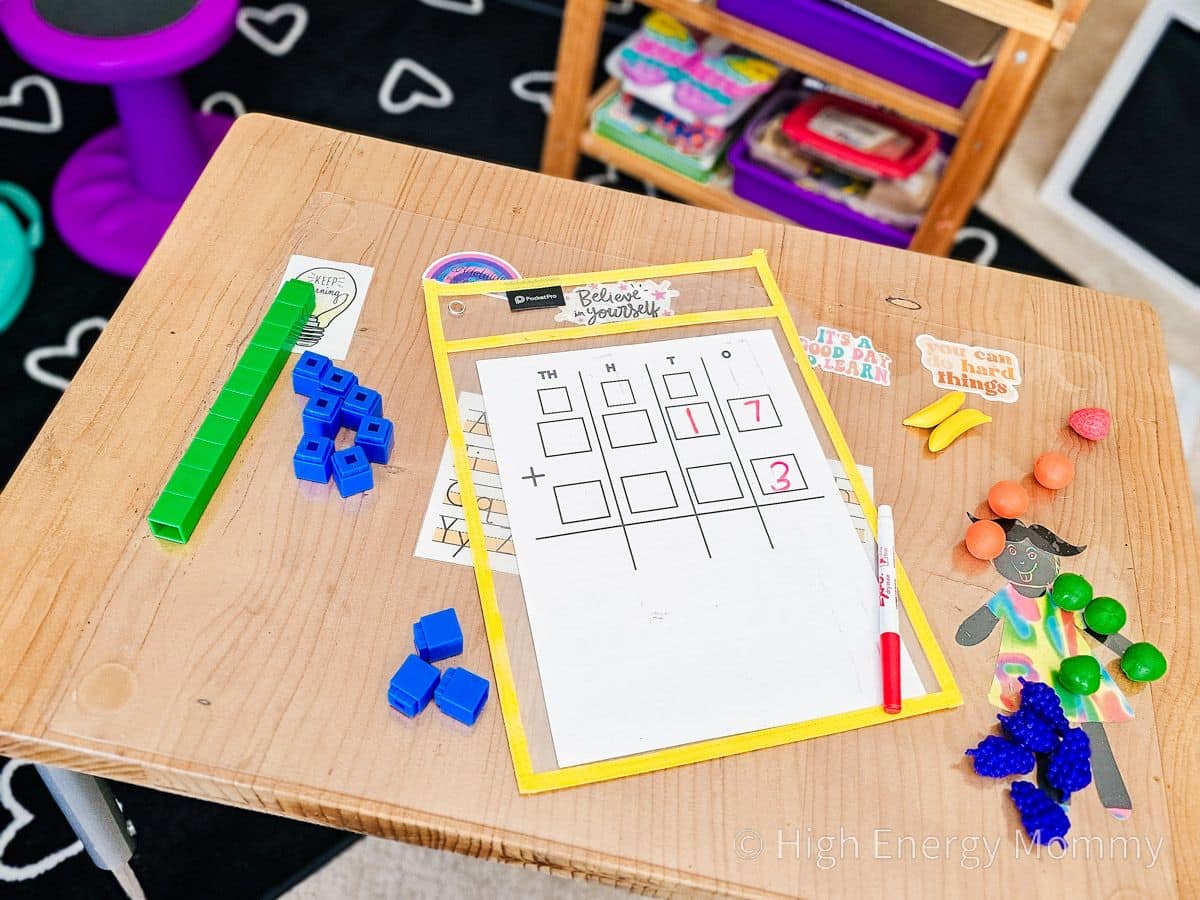 School desk with cubes, worksheet with place value and fruit math counters